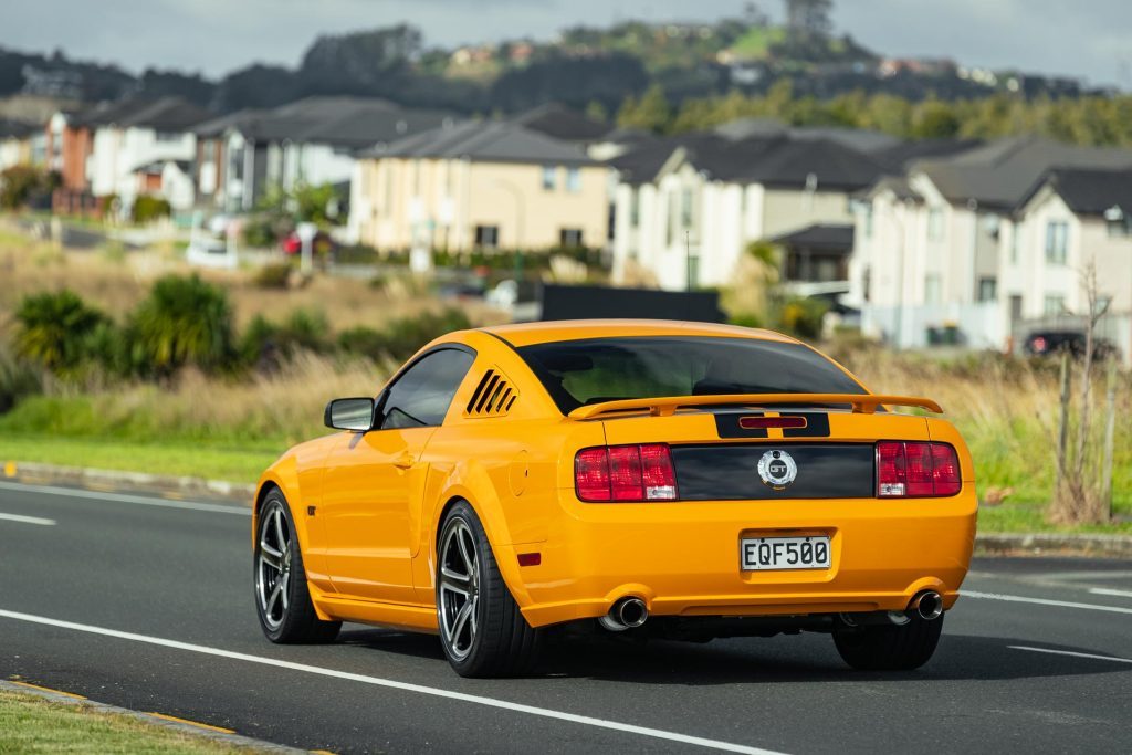 2007 Ford Mustang GT rear flyby shot, in a residential area