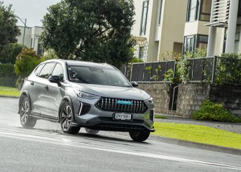 Haval Jolion Ultra Hybrid in grey, taking a corner in a suburban area