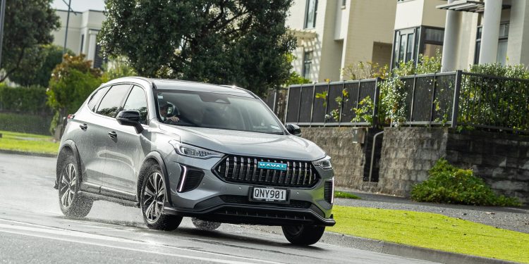 Haval Jolion Ultra Hybrid in grey, taking a corner in a suburban area