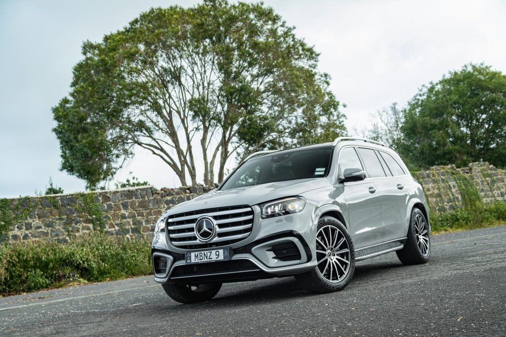 Mercedes-Benz GLS 450d 4Matic, parked with a rustic stone wall behind. Shown in silver