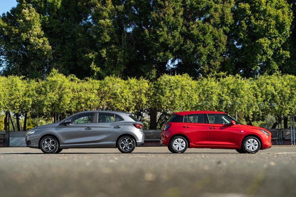 MG MG3 Essence vs Suzuki Swift GLS facing away from one another, parked in a large carpark