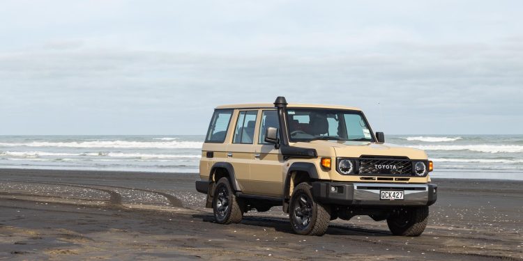 Toyota Land Cruiser 70 LX Wagon, parked on a New Zealand beach