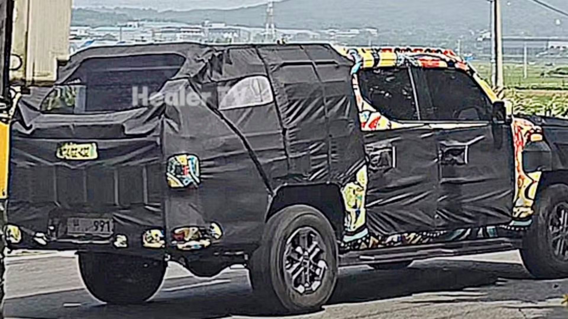 Spy shot of Kia Tasman prototype with canopy-like accessory.