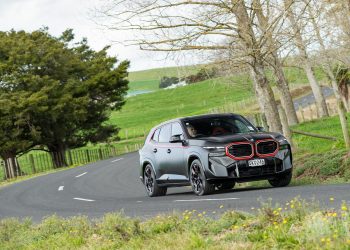 BMW XM Label Red Edition cornering at pace, on a backroad