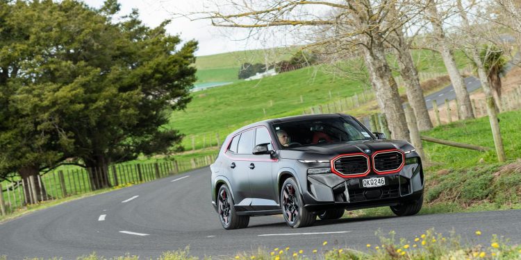 BMW XM Label Red Edition cornering at pace, on a backroad