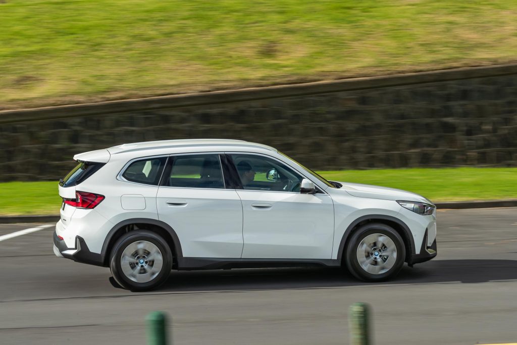 Panning side profile of the 2024 BMW iX1 eDrive20 in white