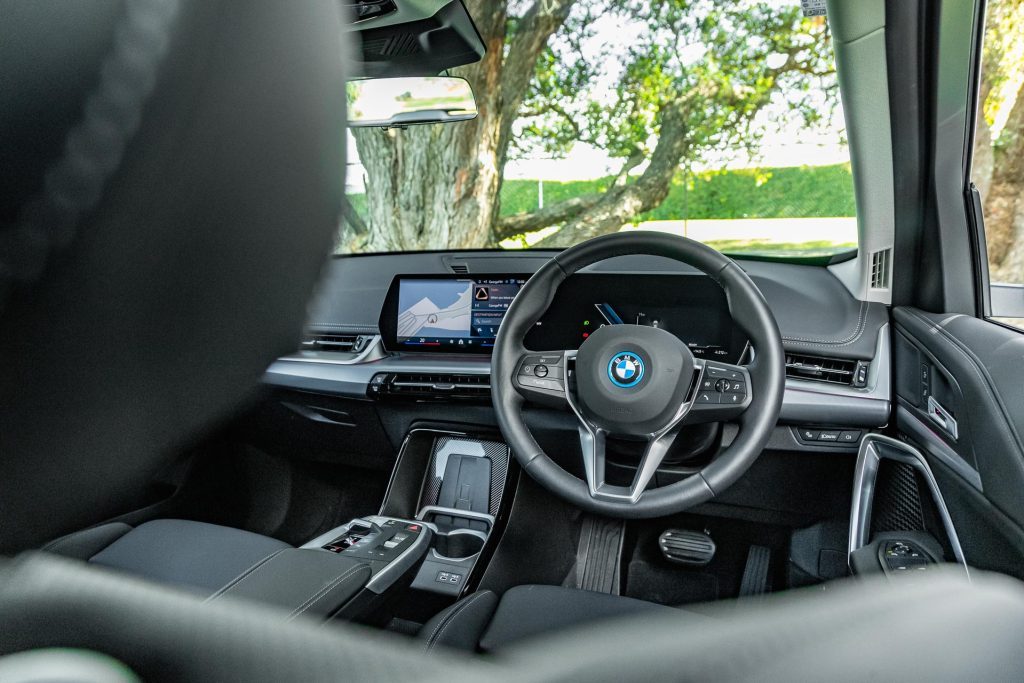 Wide interior angle of the 2024 BMW iX1 eDrive20, showing steering wheel and screens