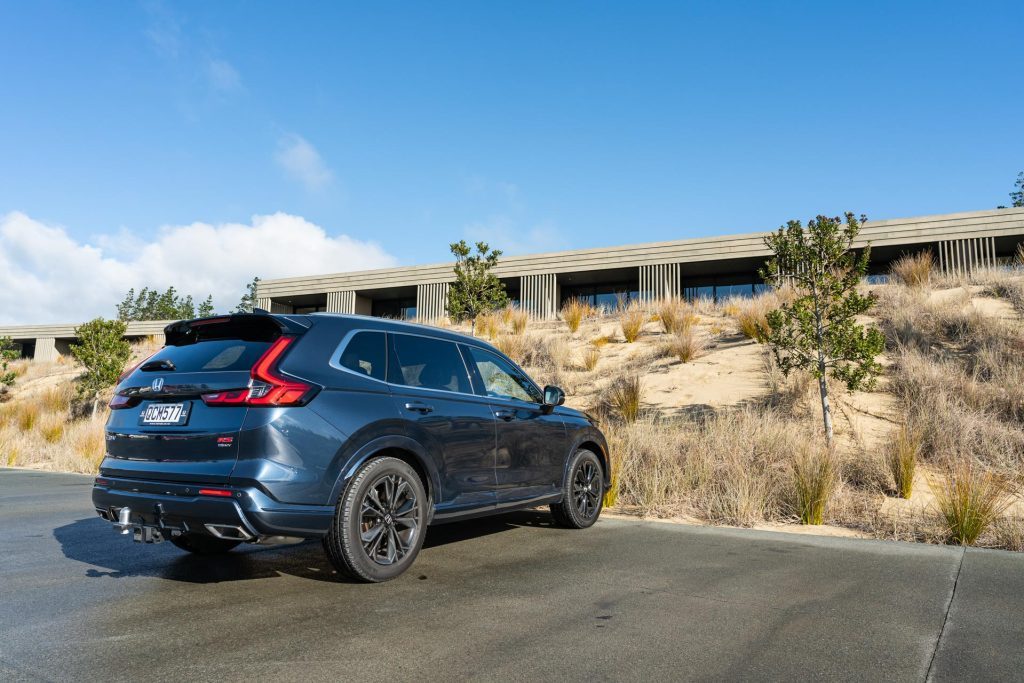 2024 Honda CR-V RS rear quarter view, parked next to a bach