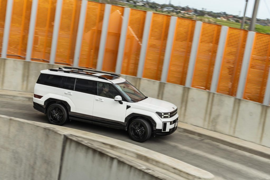 2024 Hyundai Santa Fe Hybrid driving up a parking building ramp