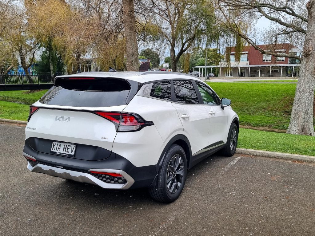 rear quarter of the 2024 Kia Sportage Earth Hybrid, parked in a carpark