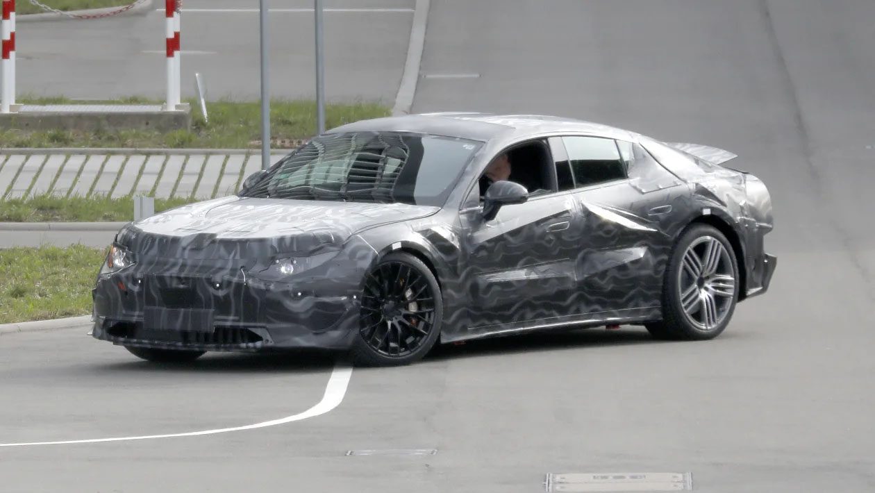 Another view of the Mercedes -AMG Taycan rival sporting heavy camouflage.