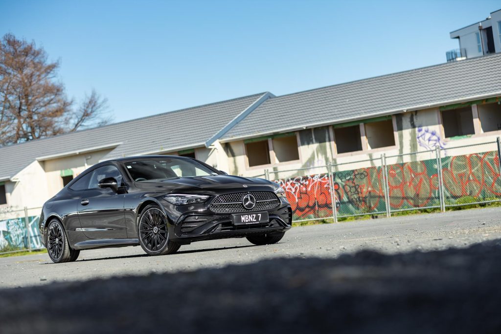 Mercedes-Benz CLE 300 4MATIC from 2024, in black, parked against a graffiti wall