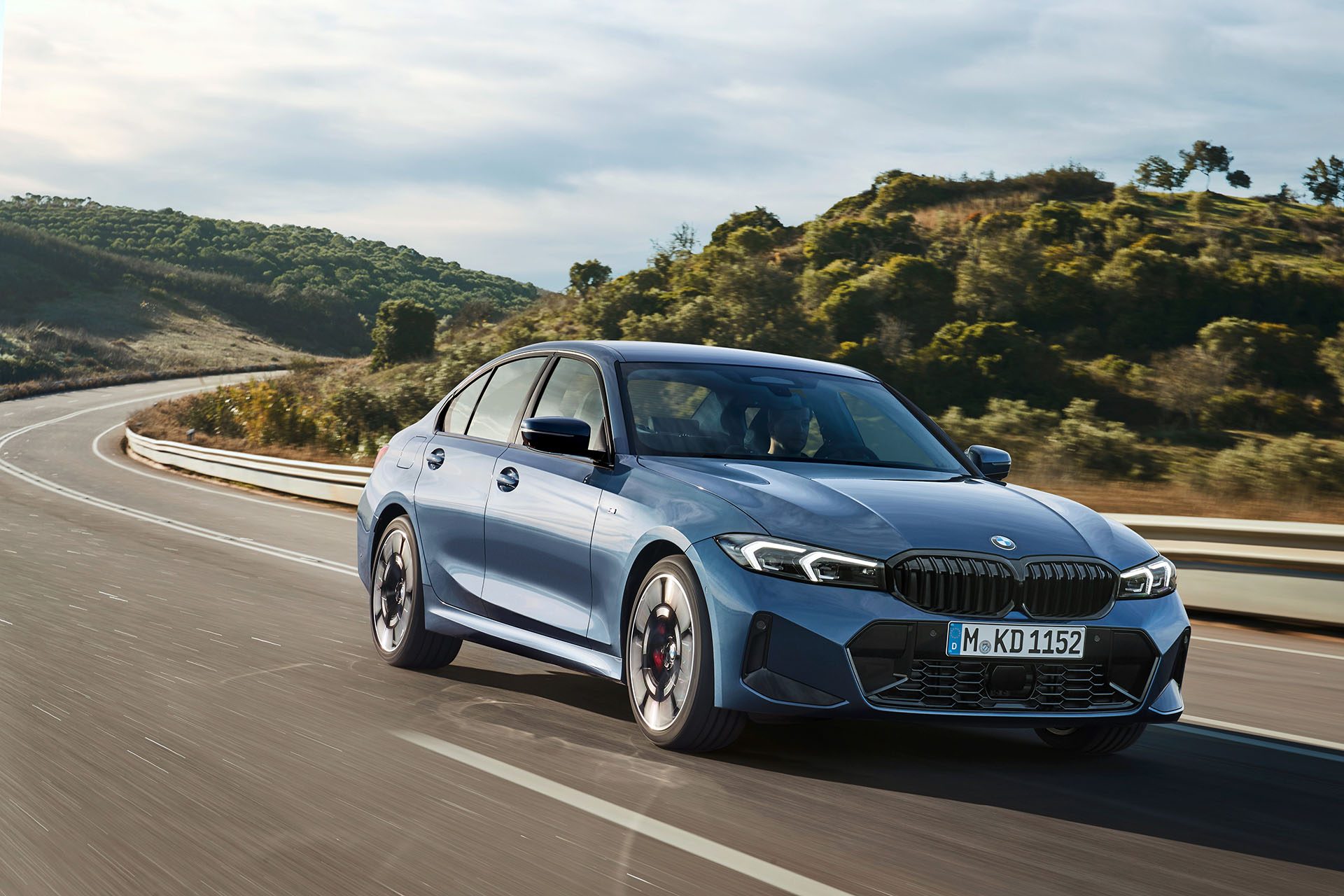 BMW 3 Series sedan on road.