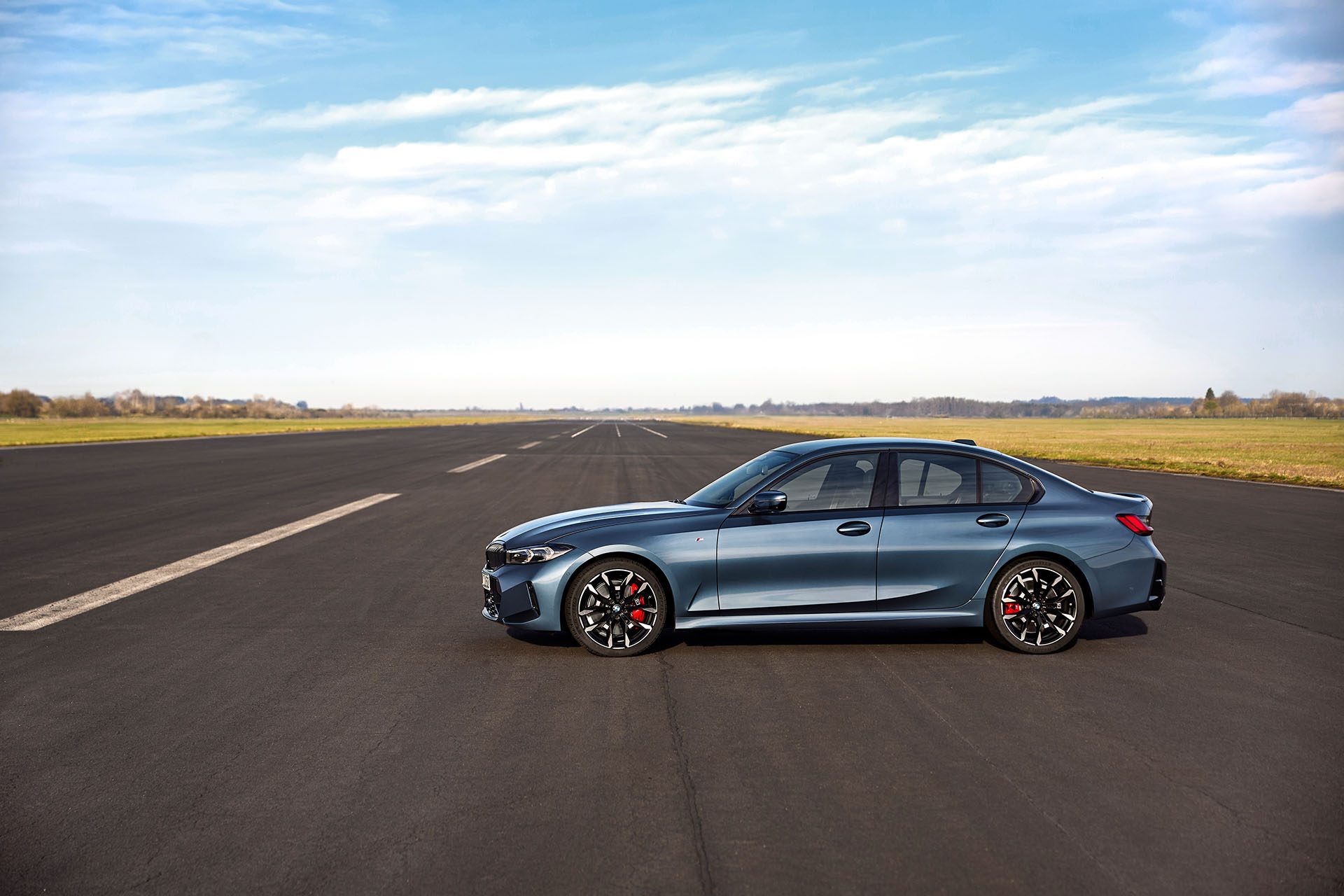 BMW 3 Series at rest on runway.