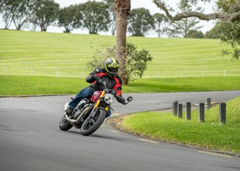 Triumph Speed 400 bike cornering next to an Auckland park