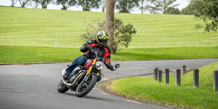 Triumph Speed 400 bike cornering next to an Auckland park