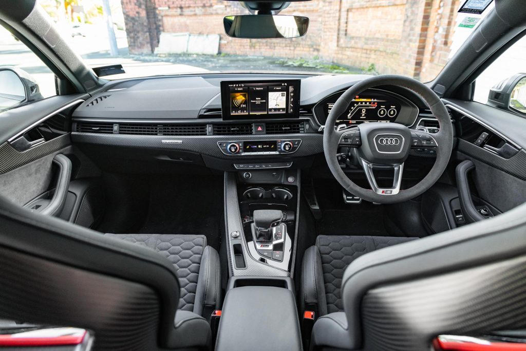 Wide interior view of the 2024 Audi RS 4 Competition Plus, showing seats and steering wheel and dash