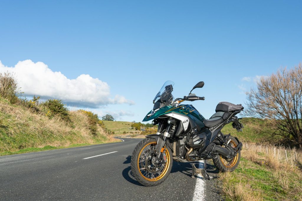 Front quarter shot of the 2024 BMW R 1300 GS parked next to a backroad