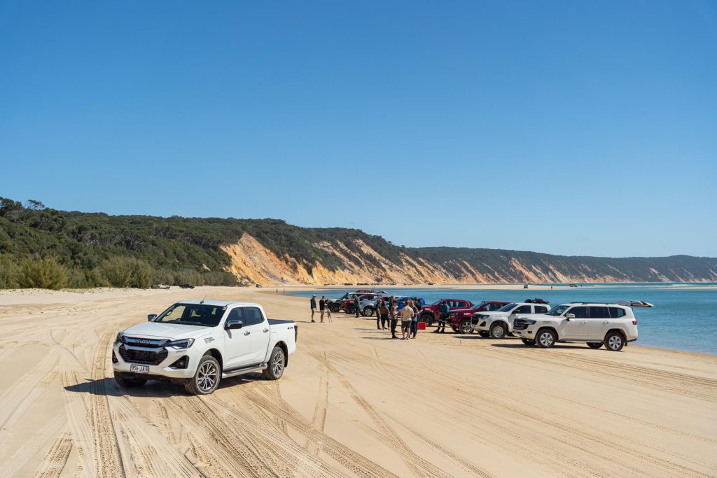 White Isuzu parked infront of travel group at Rainbow beach