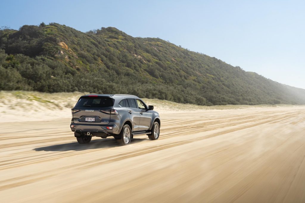 Rolling beach shot of an Isuzu MU-X at Noosa beach