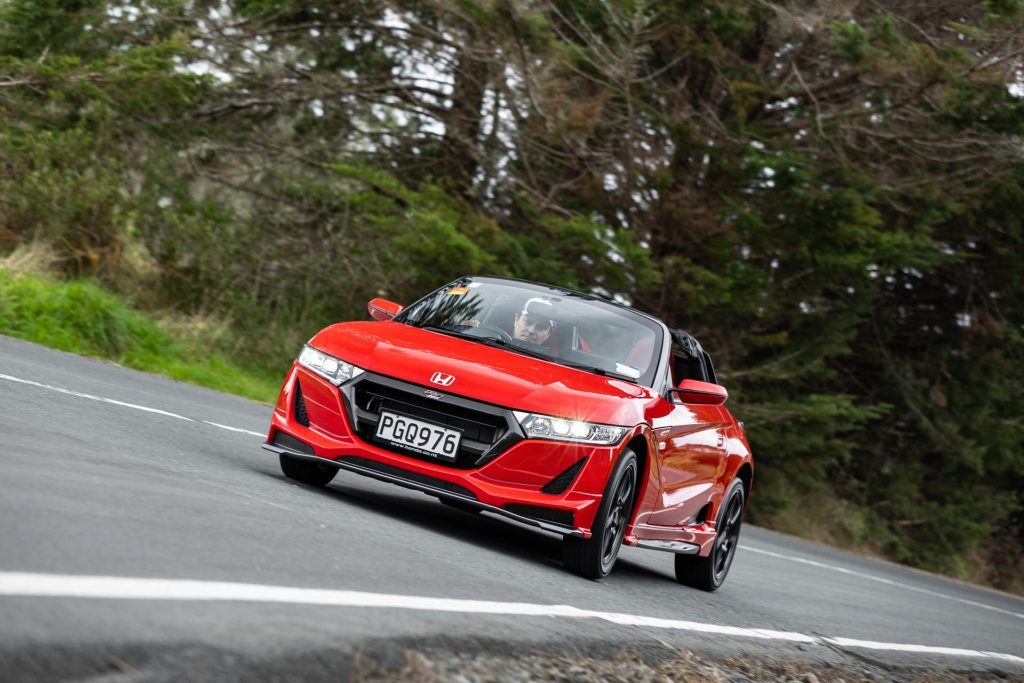 Honda S660 Mugen RA taking a corner in red