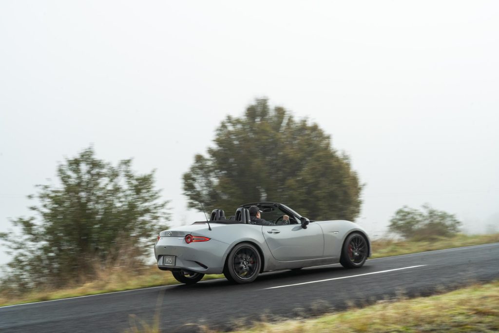 Rear panning corner shot of the 2024 Mazda MX-5 GT in grey