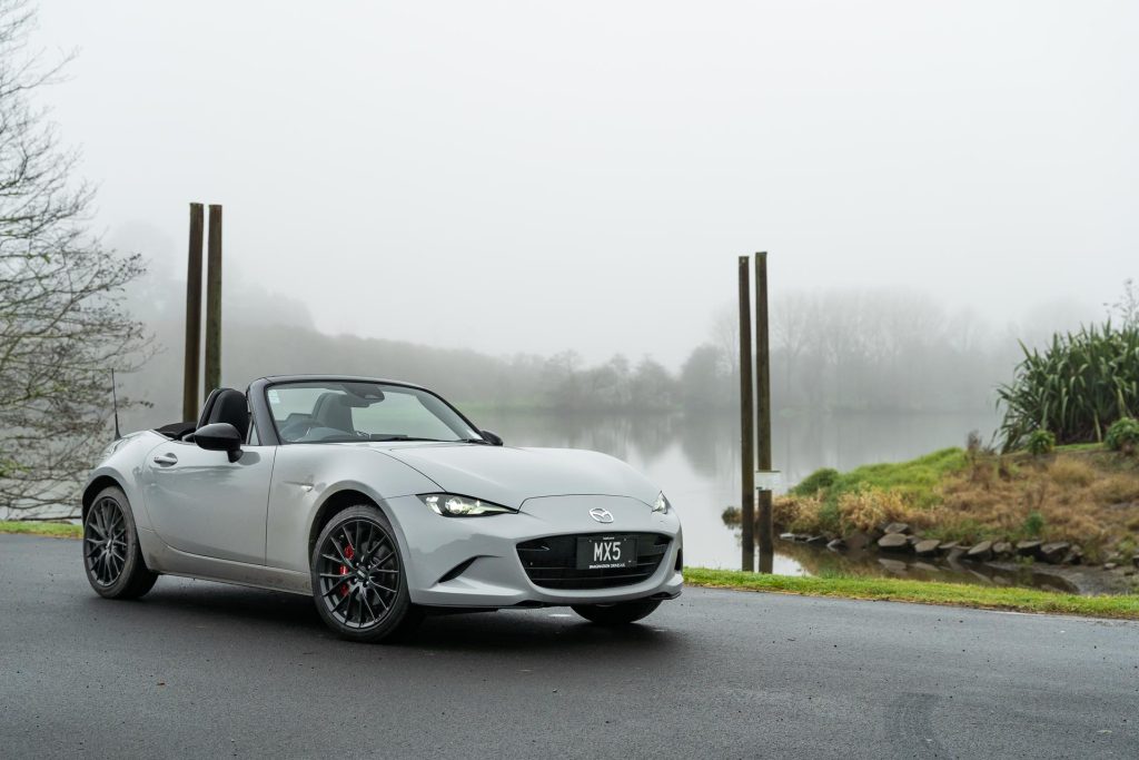 2024 Mazda MX-5 GT in grey, parked front quarter forward, near the Waikato river