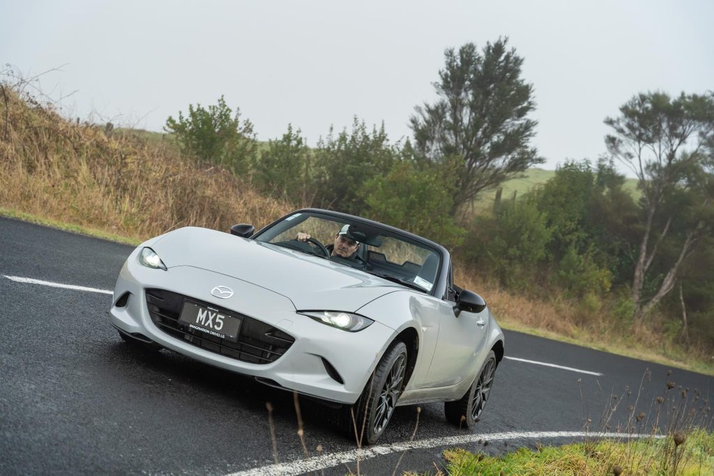 2024 Mazda MX-5 GT taking a corner, leaning over at speed