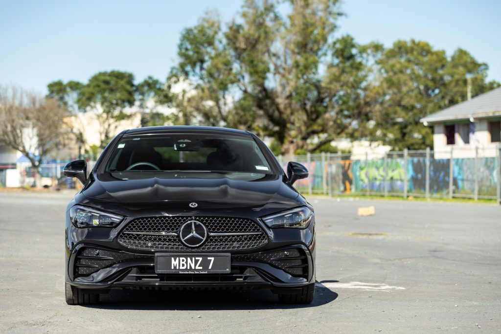 Front profile shot of the 2024 Mercedes-Benz CLE 300, with a graffiti background