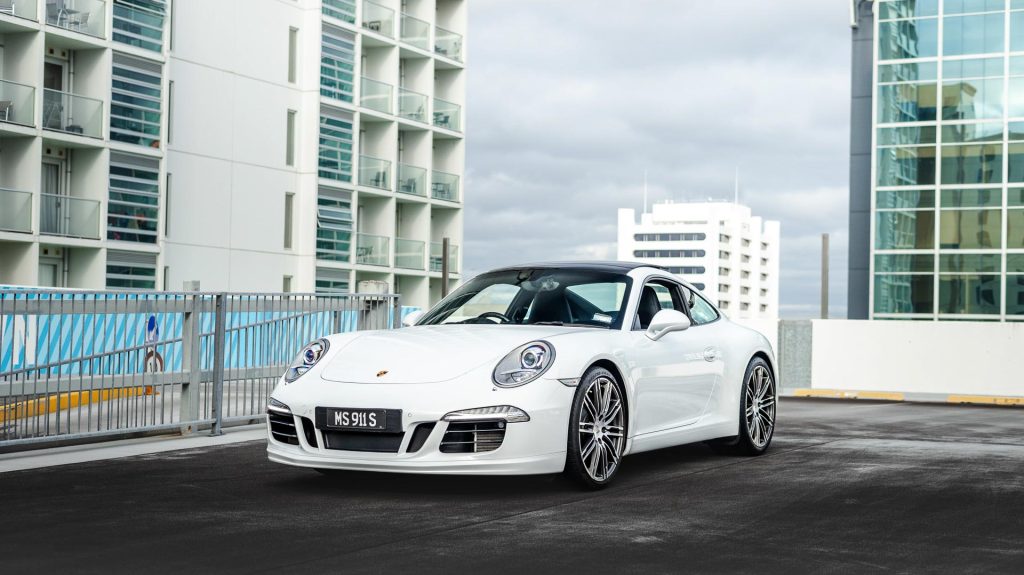 Porsche 911 Carrera S in white, parked on a rooftop