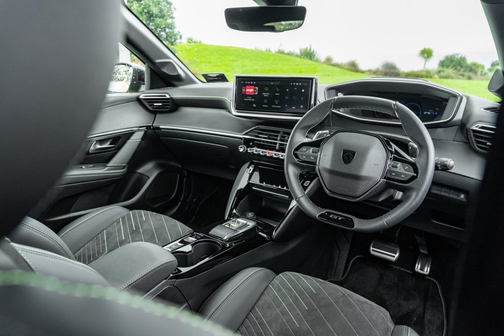 2024 Peugeot 208 GT Hybrid interior wide shot, showing steering wheel and seats