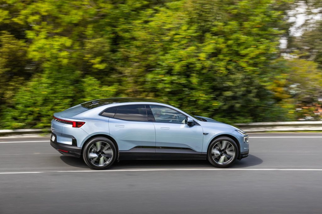 Polestar 4 Long Range in blue, taking a corner, shown in a panning shot