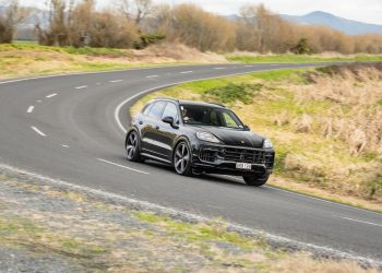 Porsche Cayenne GTS taking a corner at pace on a backroad