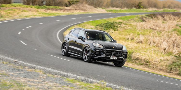 Porsche Cayenne GTS taking a corner at pace on a backroad