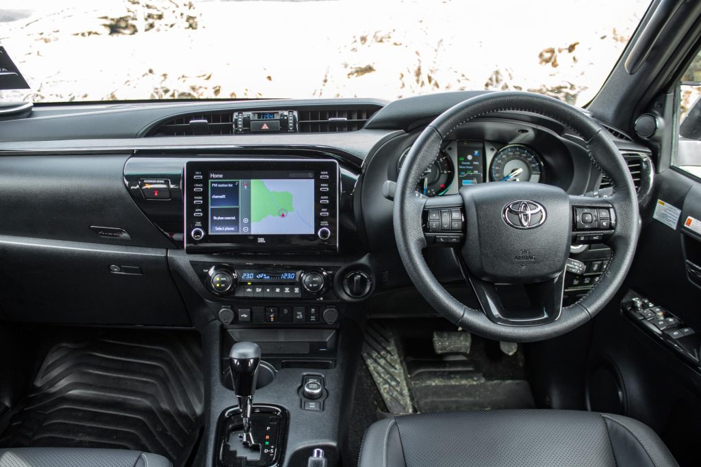 2024 Toyota Hilux SR5 Cruiser Hybrid interior view, showing steering wheel and dash