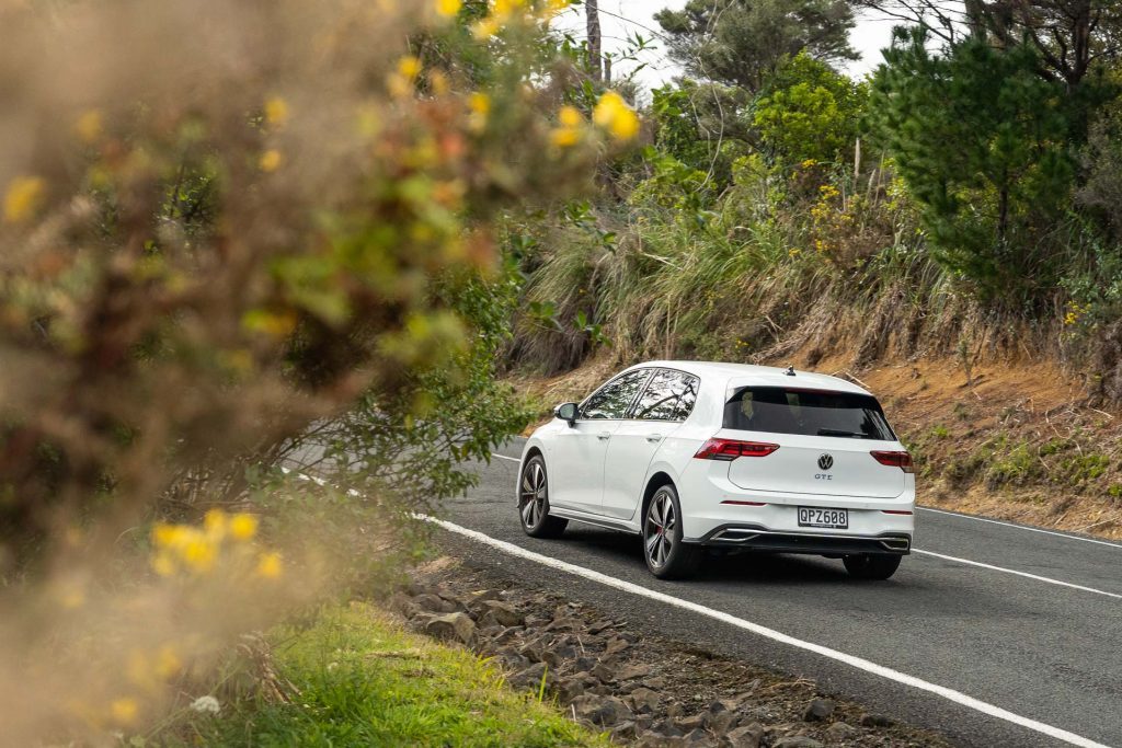 2024 Volkswagen Golf GTE from the rear, taking a corner