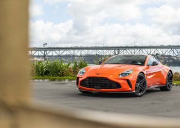 Aaston Martin Vantage 2024, in orange, parked near Auckland's Harbour bridge