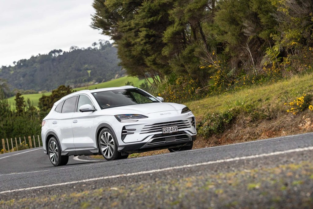 BYD in white taking a corner on an Auckland backroad