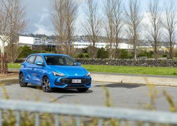 MG MG3 Hybrid Essence, parked in a carpark with trees behind, and a fence in front