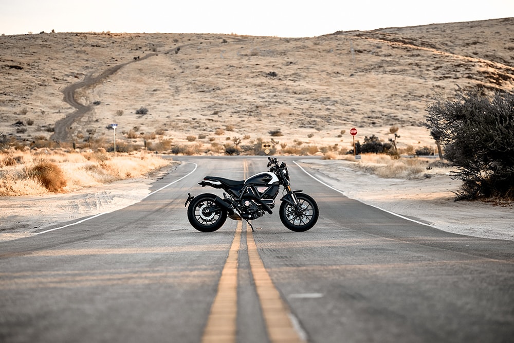 Scrambler parked randomly during a road ride.