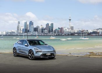 Polestar 4 Long Range dual motor, parked in front of Auckland's city scape