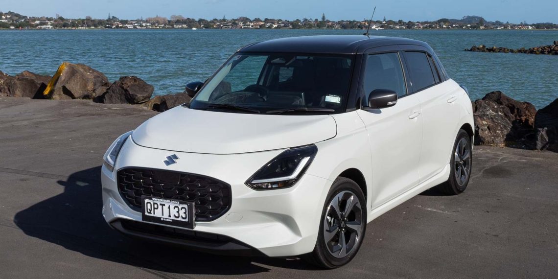 White Suzuki Swift RSC in white, parked next to the sea