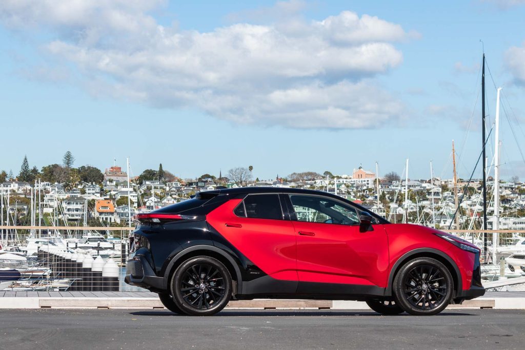 Toyota C-HR GR Sport Hybrid E-Four 2024, in red and black, parked in Auckland