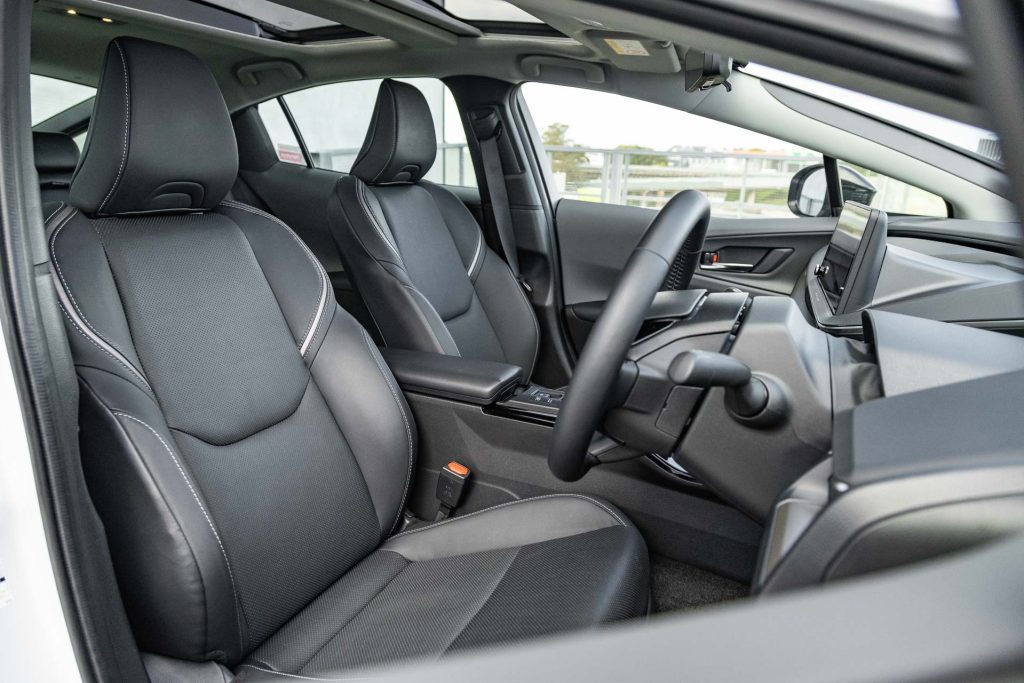 Wide interior view of the 2024 Prius, showing front seats