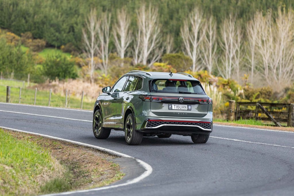 rear cornering shot, with car pictured in olive green