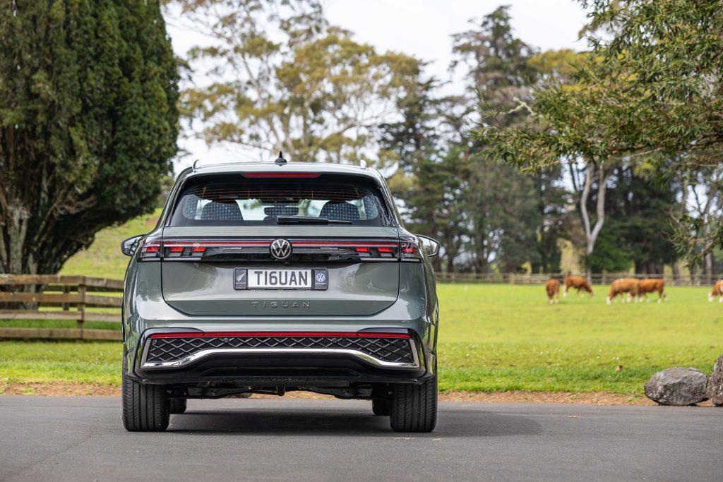 Rear profile shot of tail lights and rear design, with cows in background