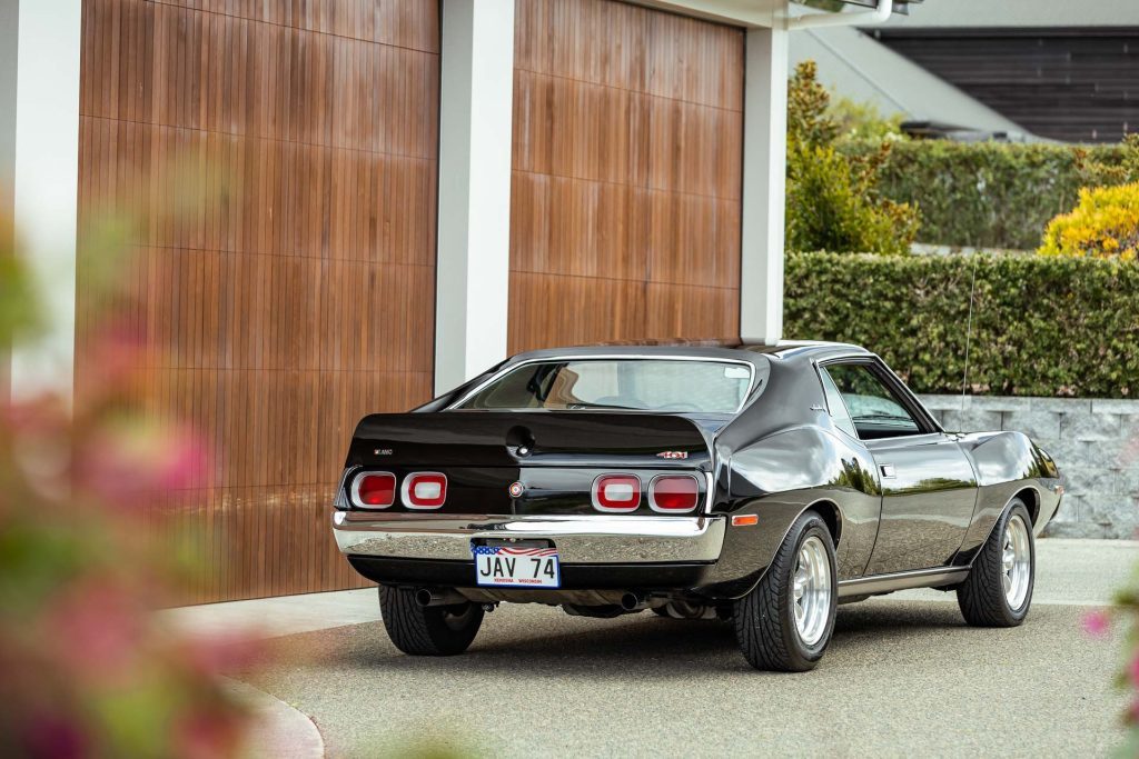 AMC Javelin 401 in black, rear quarter shot, with flowers in foreground