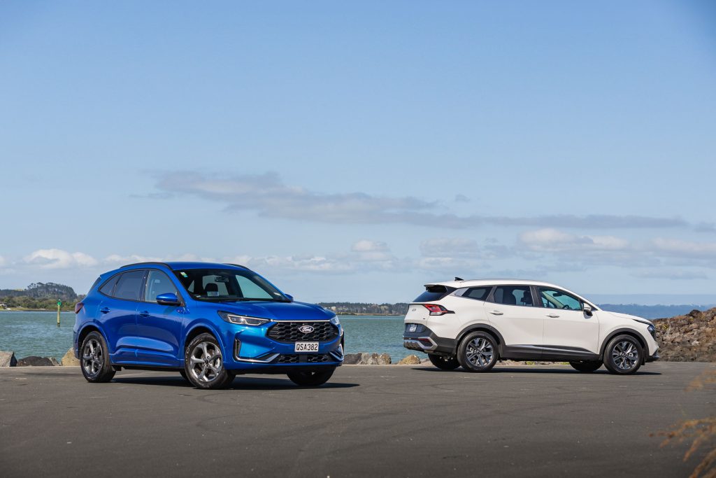 Ford Escape vs Kia Sportage, parked next to each other in comparison