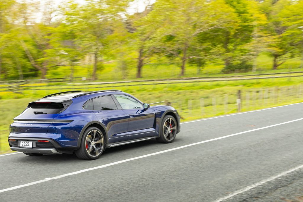 Rear Taycan Cross Turismo cornering action shot, pictured in blue