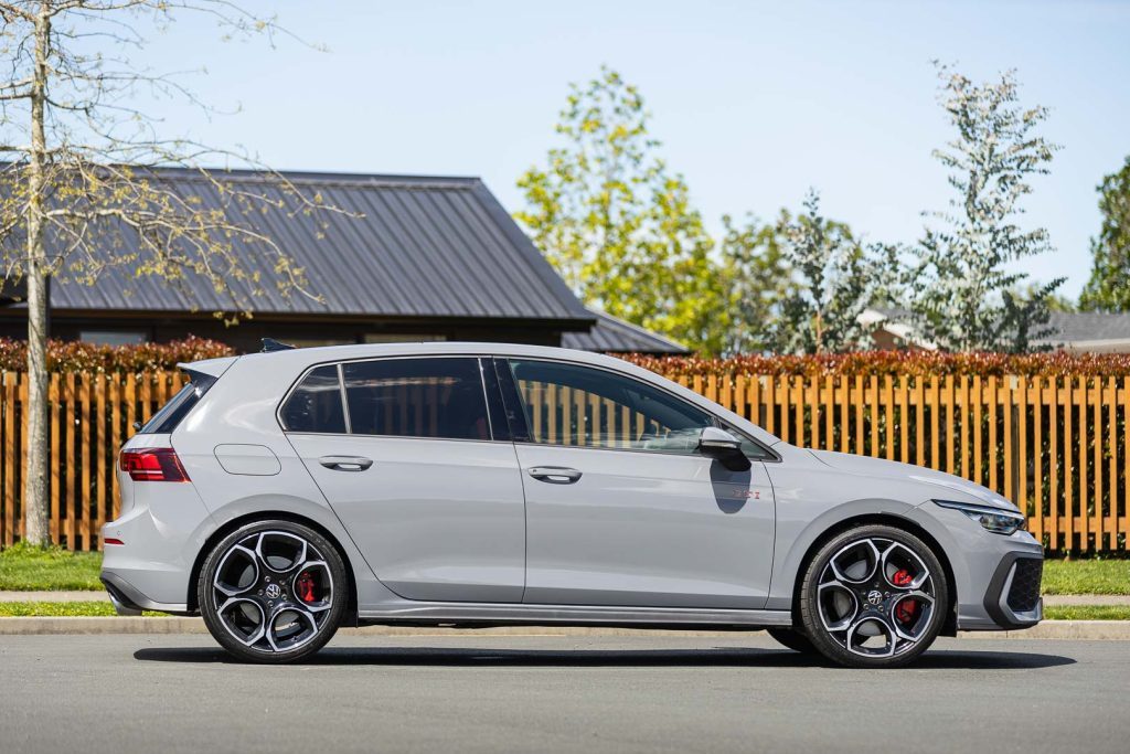 Side profile of the 2024 Golf GTI, showing 5 spoke wheels and red brakes